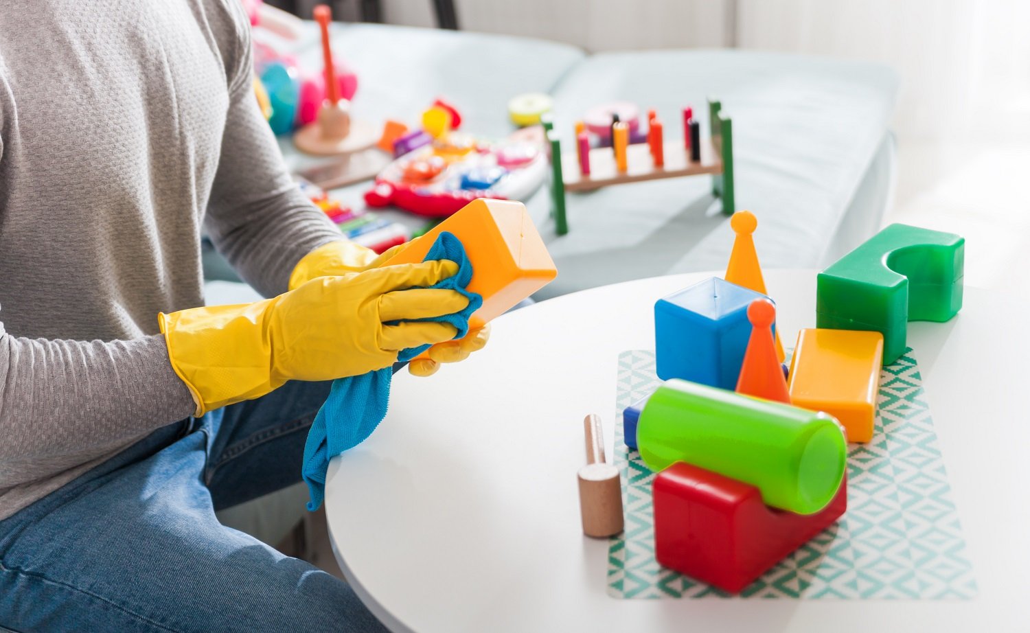 Close up of a father cleaning toys with rag