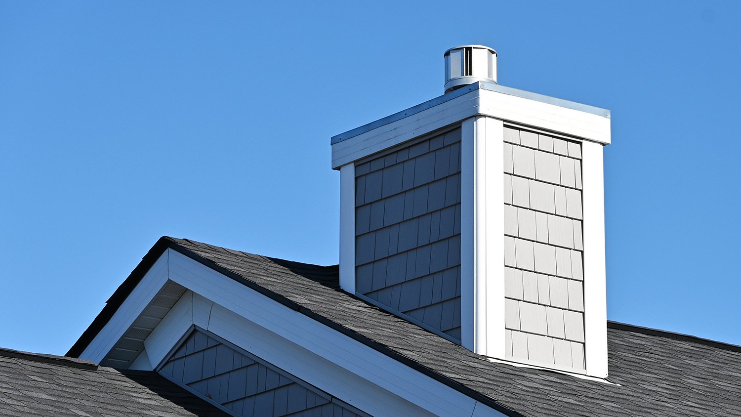 Roof of a house with a fiber cement chimney