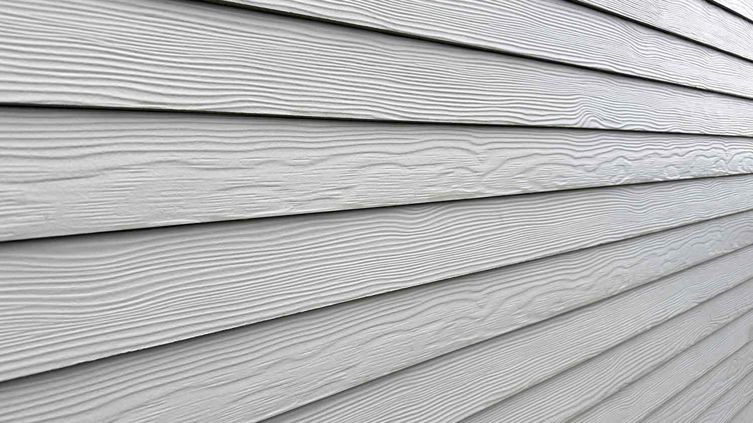 Detail of gray fiber cement cladding installed on a wall