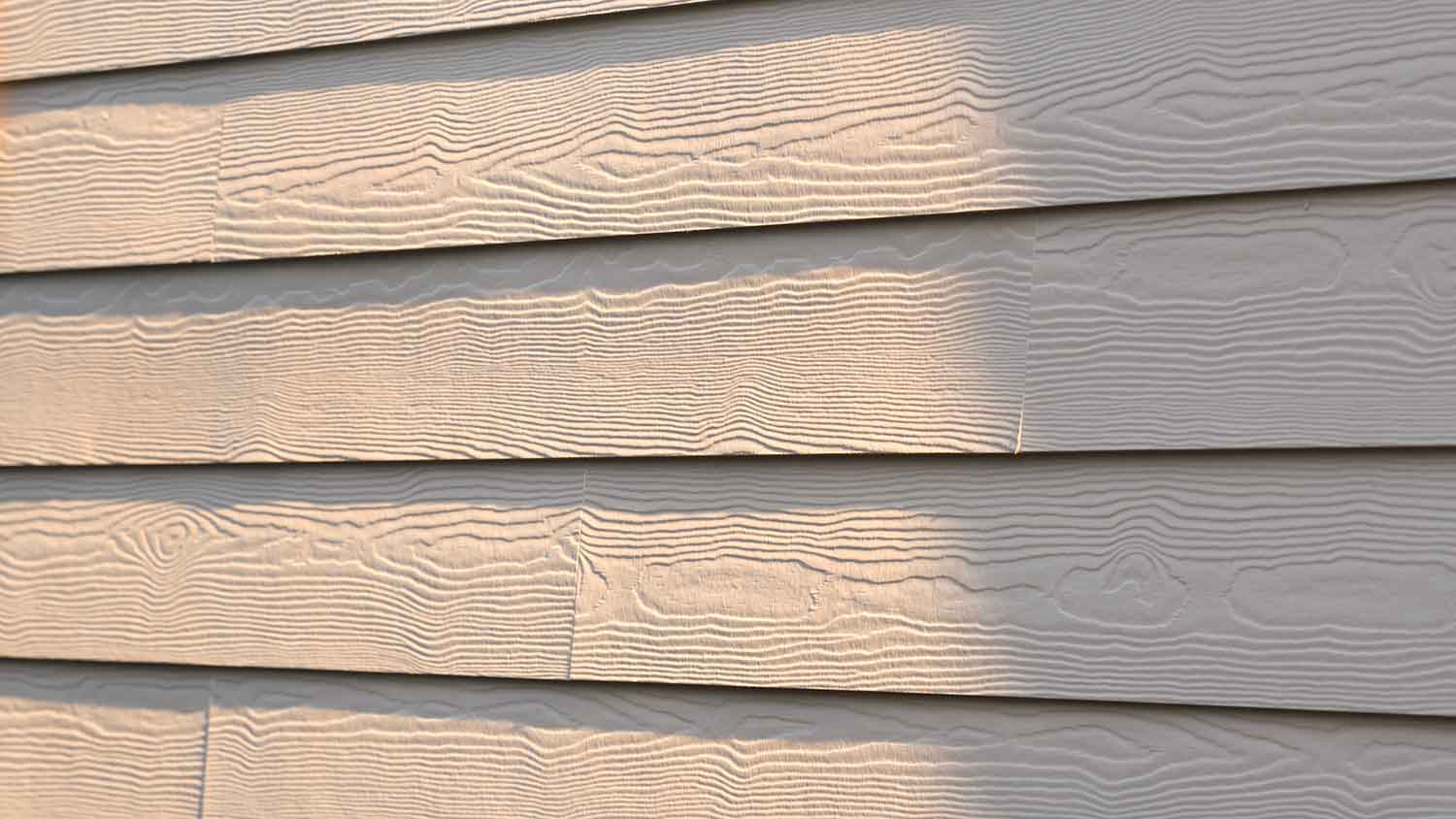 Closeup of fiber cement siding installed on a house