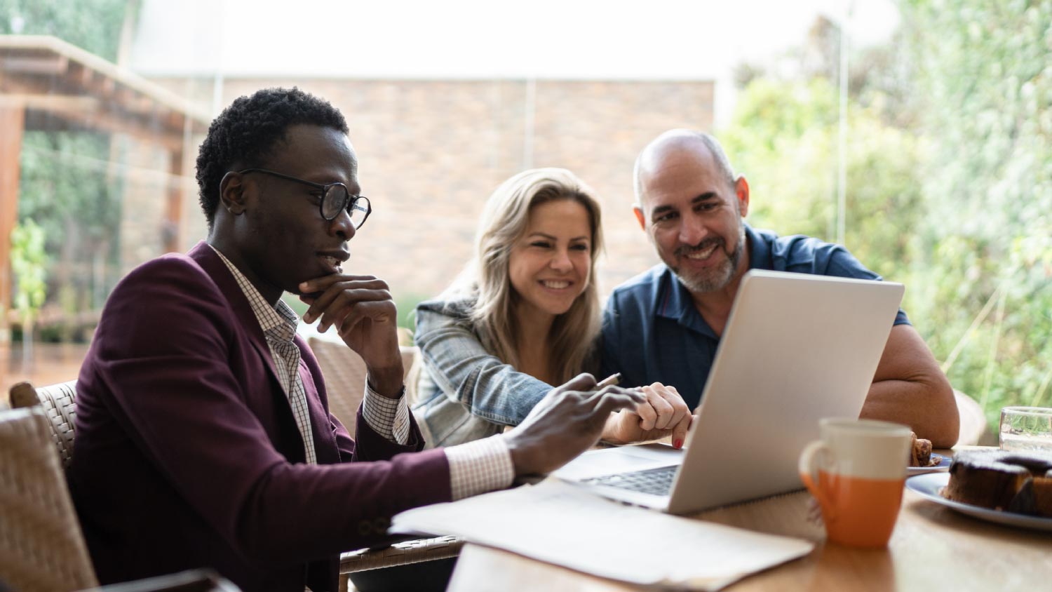 Finance advisor doing a meeting with couple at home