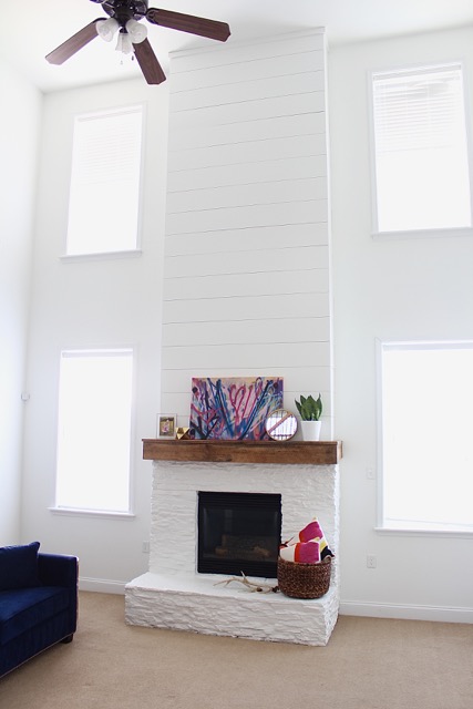 white-painted-stone-fireplace-with-shiplap-chimney