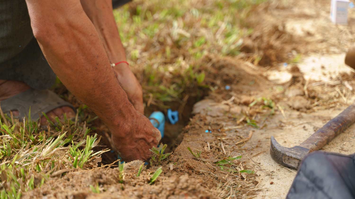 plumber fixing pipes in yard