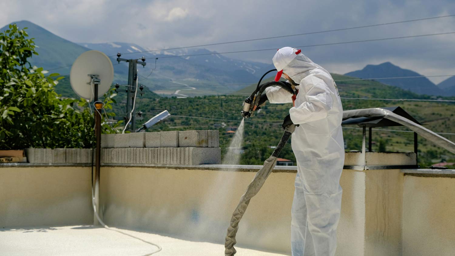 man spraying foam roof
