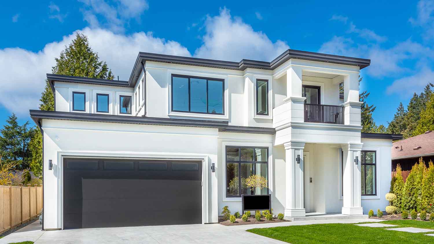 Suburban house with a concrete driveway and a flat roof