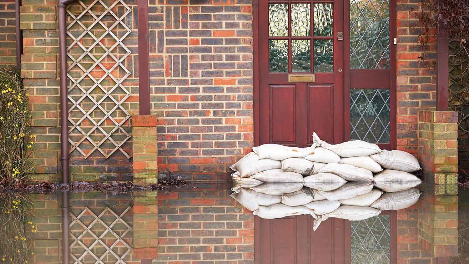 Sandbags outside of a flooded brick house