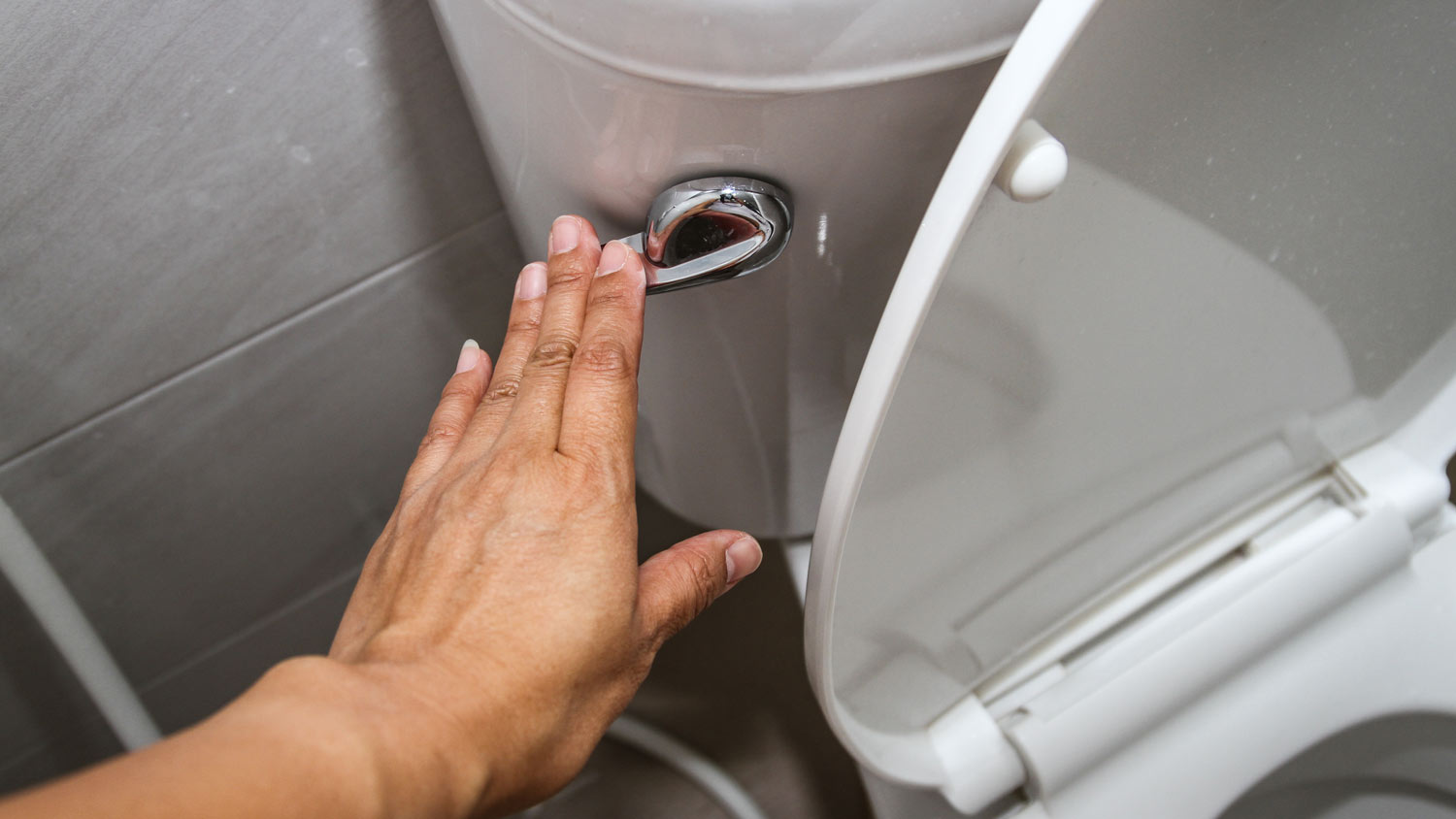  woman flushing toilet bowl  