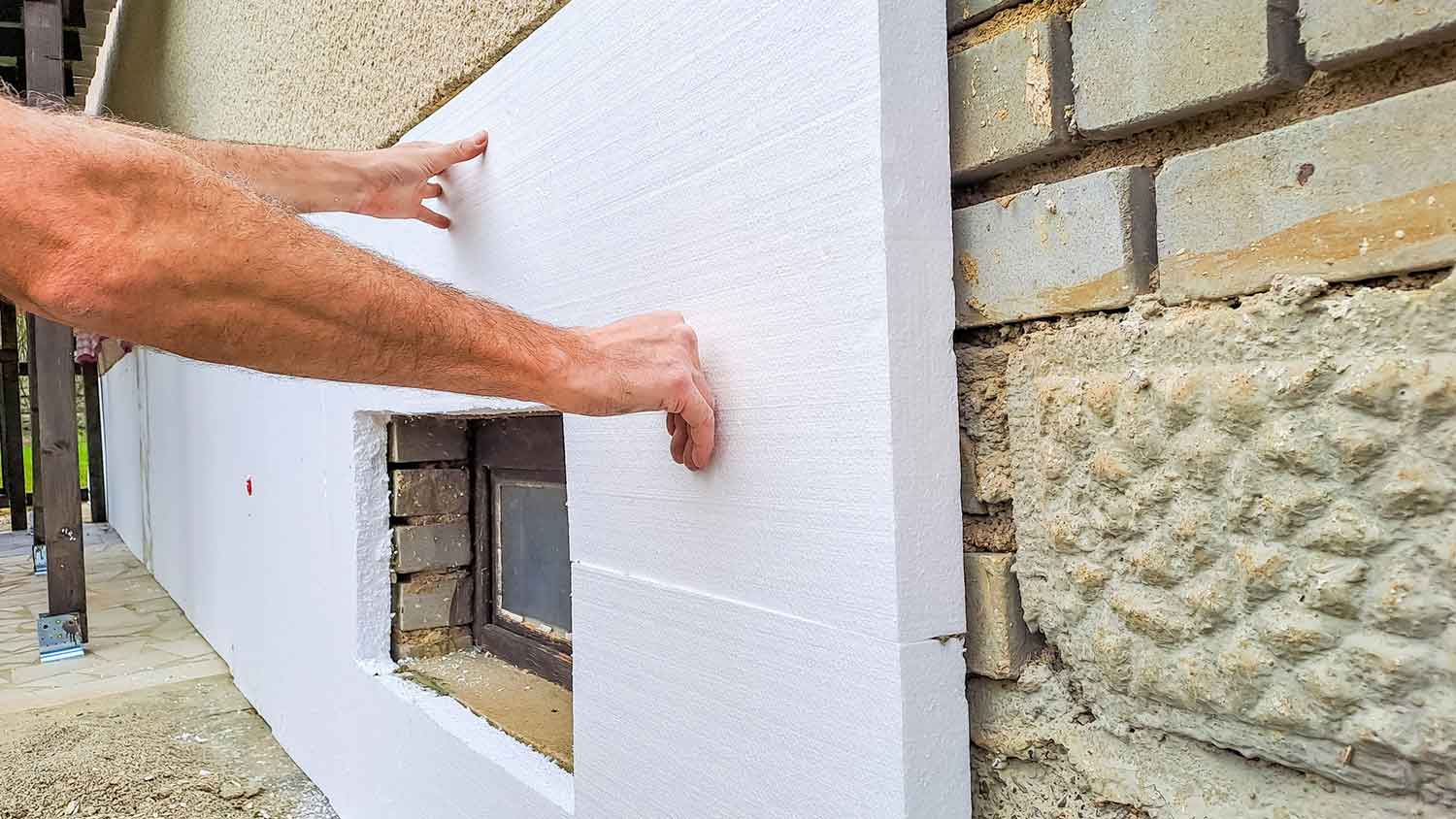 Foam board installation on a basement foundation wall