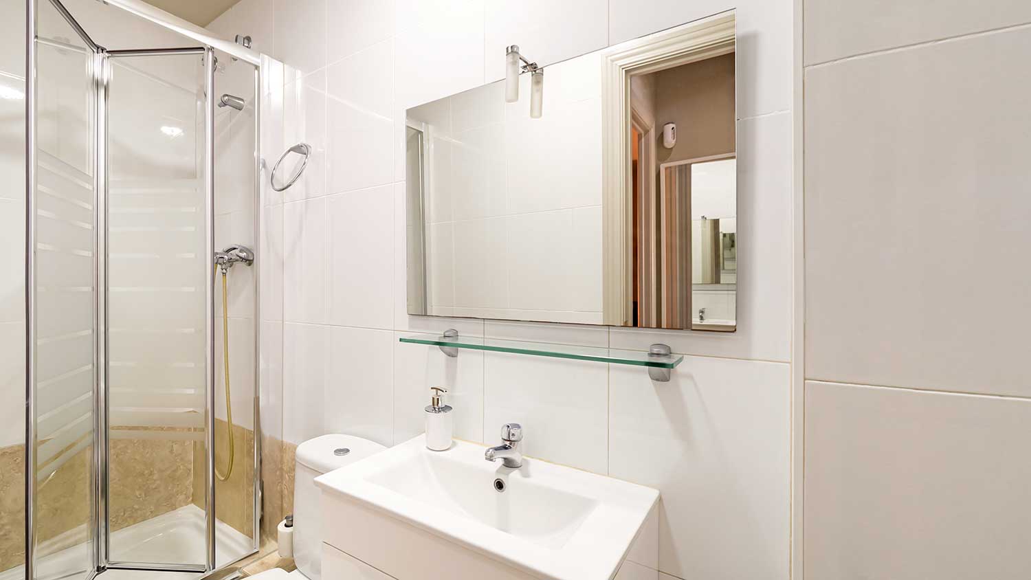 Bi-folding shower door installed in a small bathroom