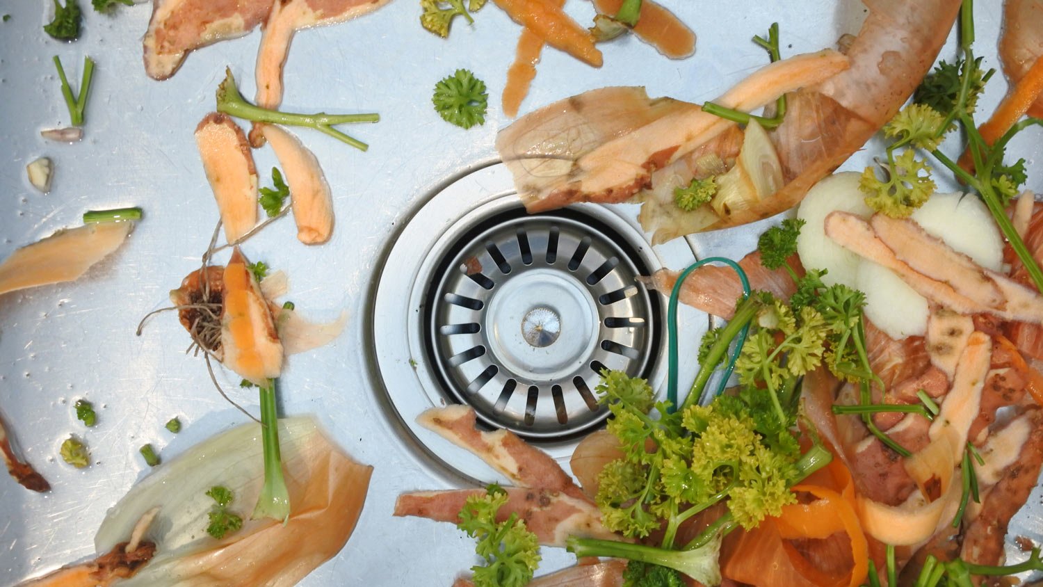 Mix of vegetables waste in home kitchen sin
