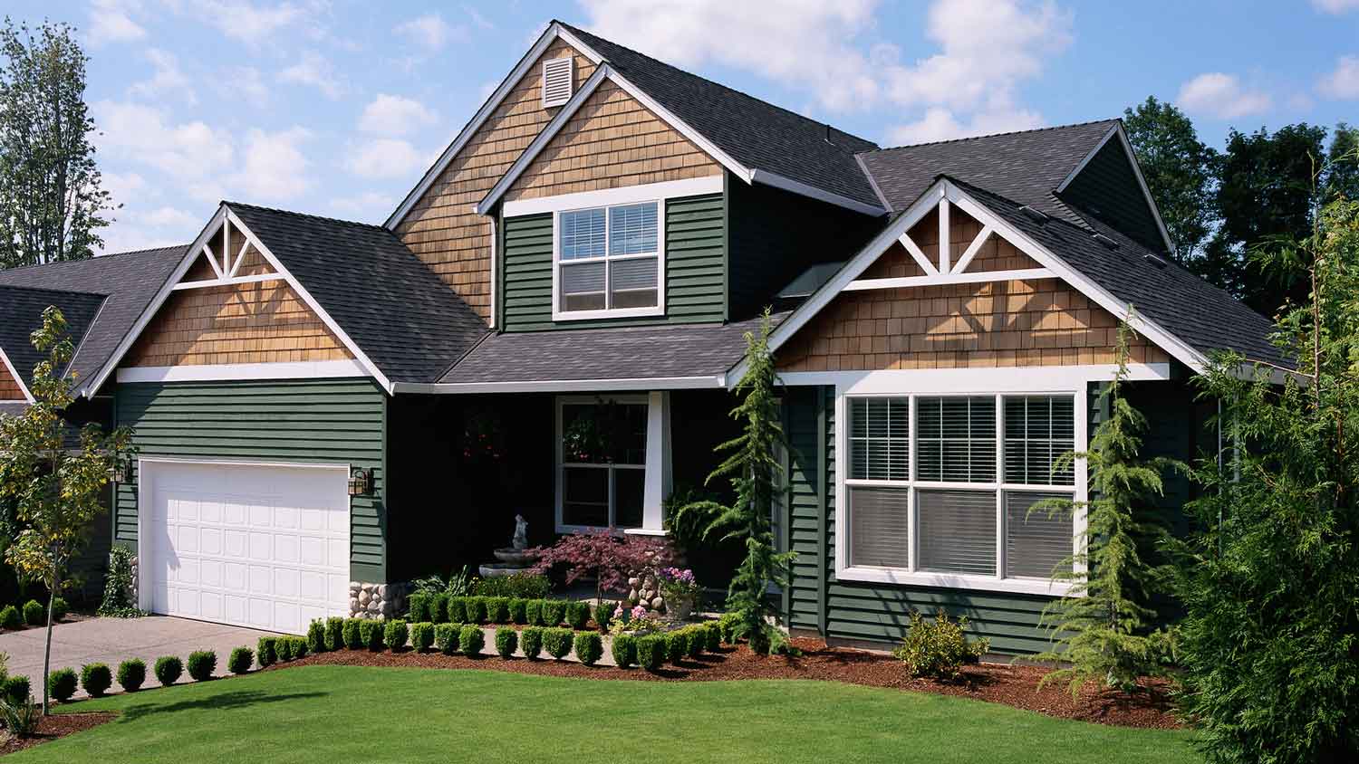 A forest green painted suburban house