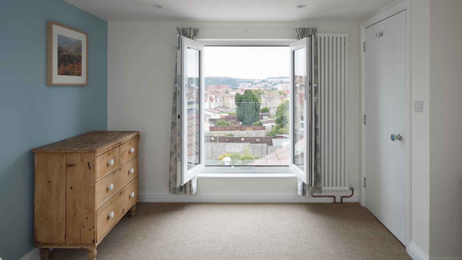 Bedroom with french windows open