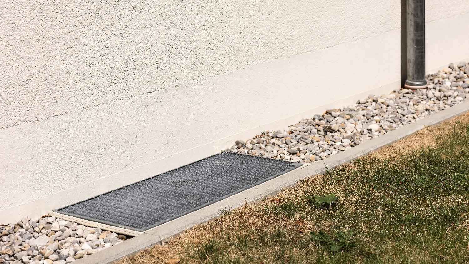 A french drain on a yard with lawn