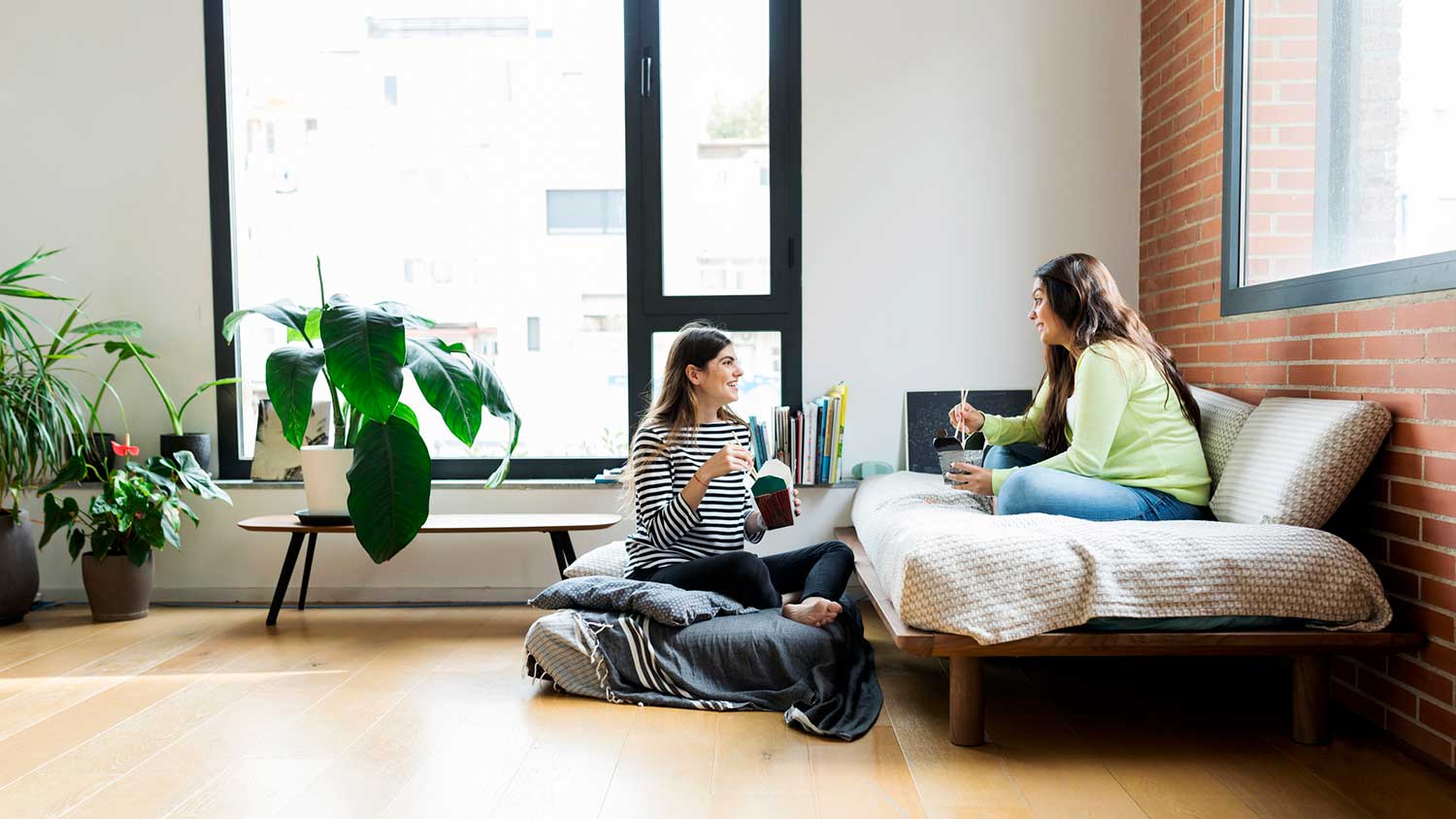 Two friends eating lunch at home