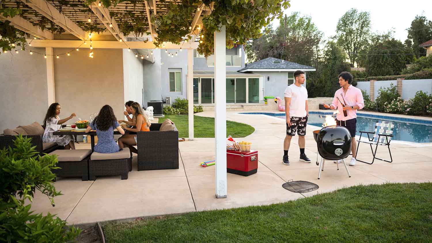 Group of friends enjoying BBQ on the patio