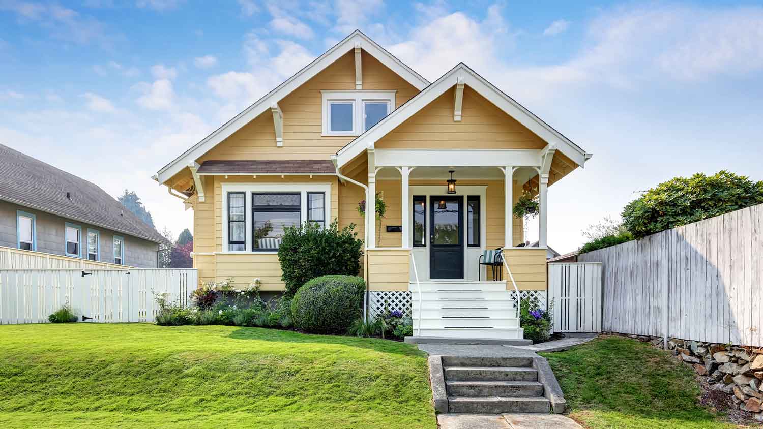 Narrow yellow home with front gable roof