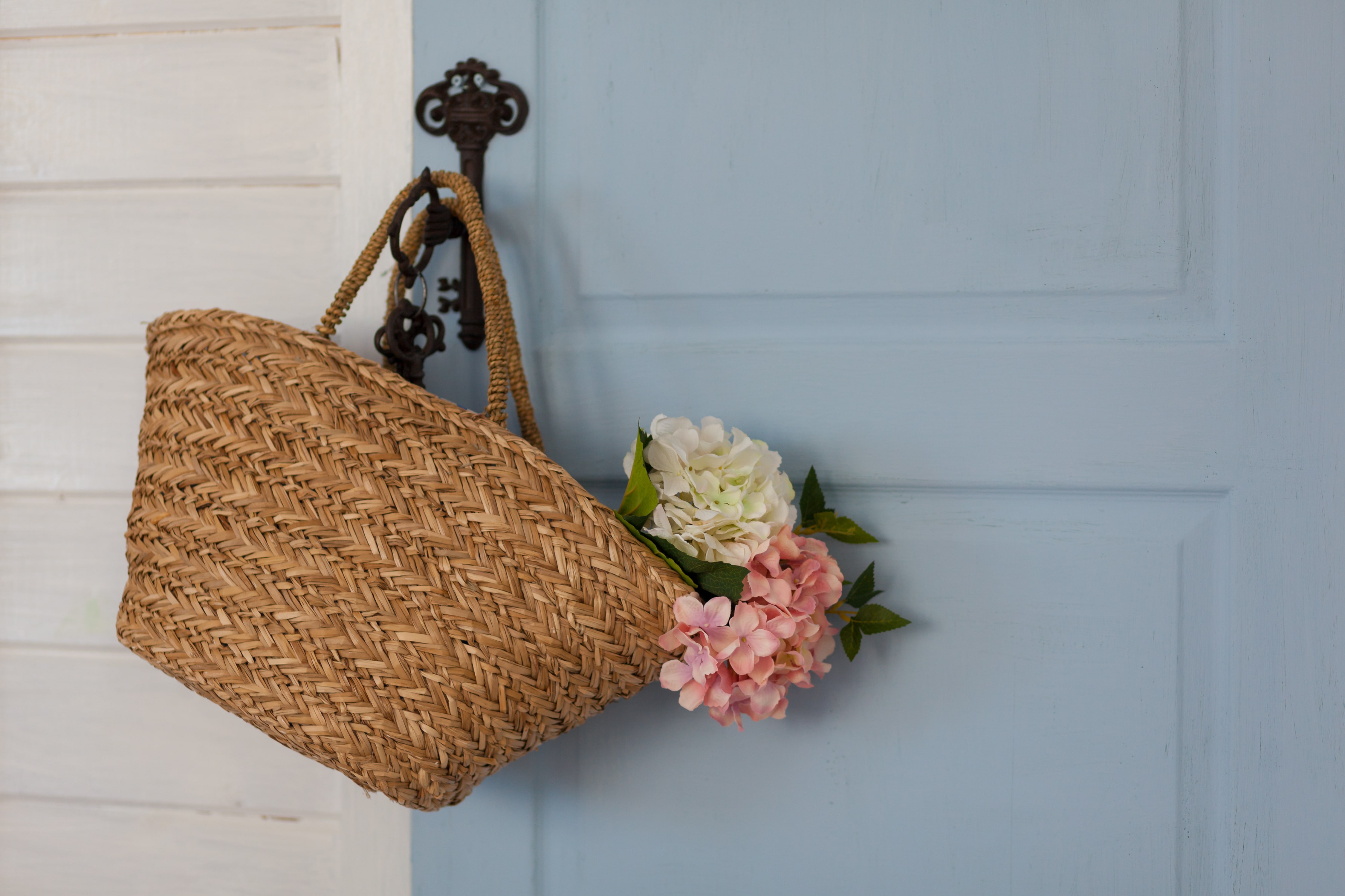 Hanging rattan flower basket from front entryway door