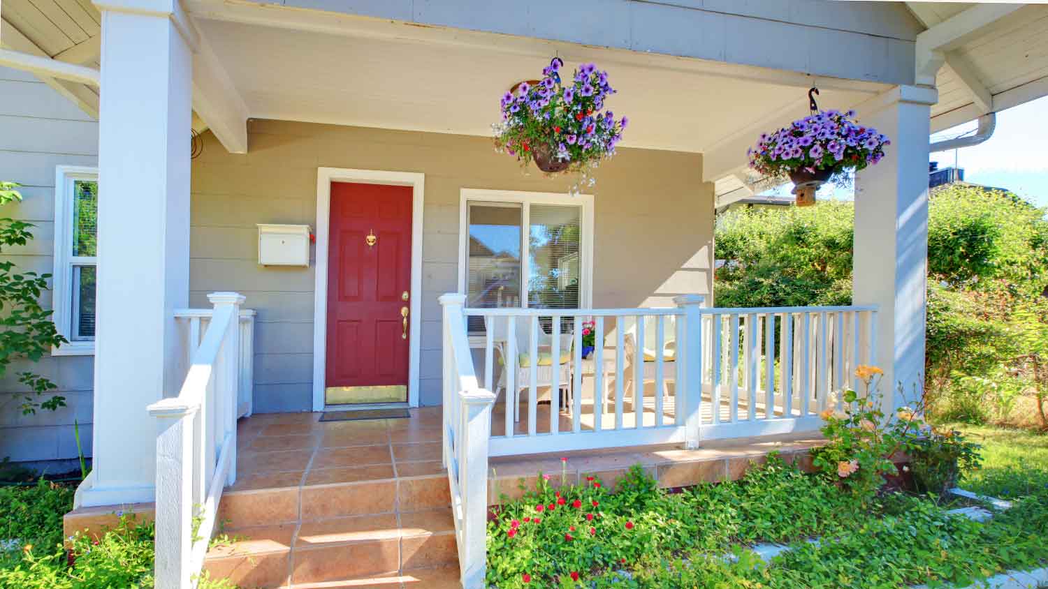 Front porch of a house with red front door