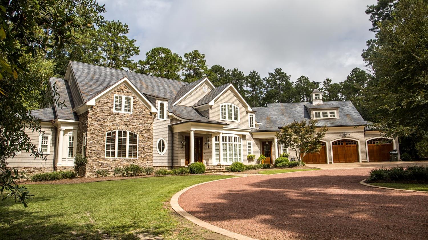 The front view of a large estate with its own private road