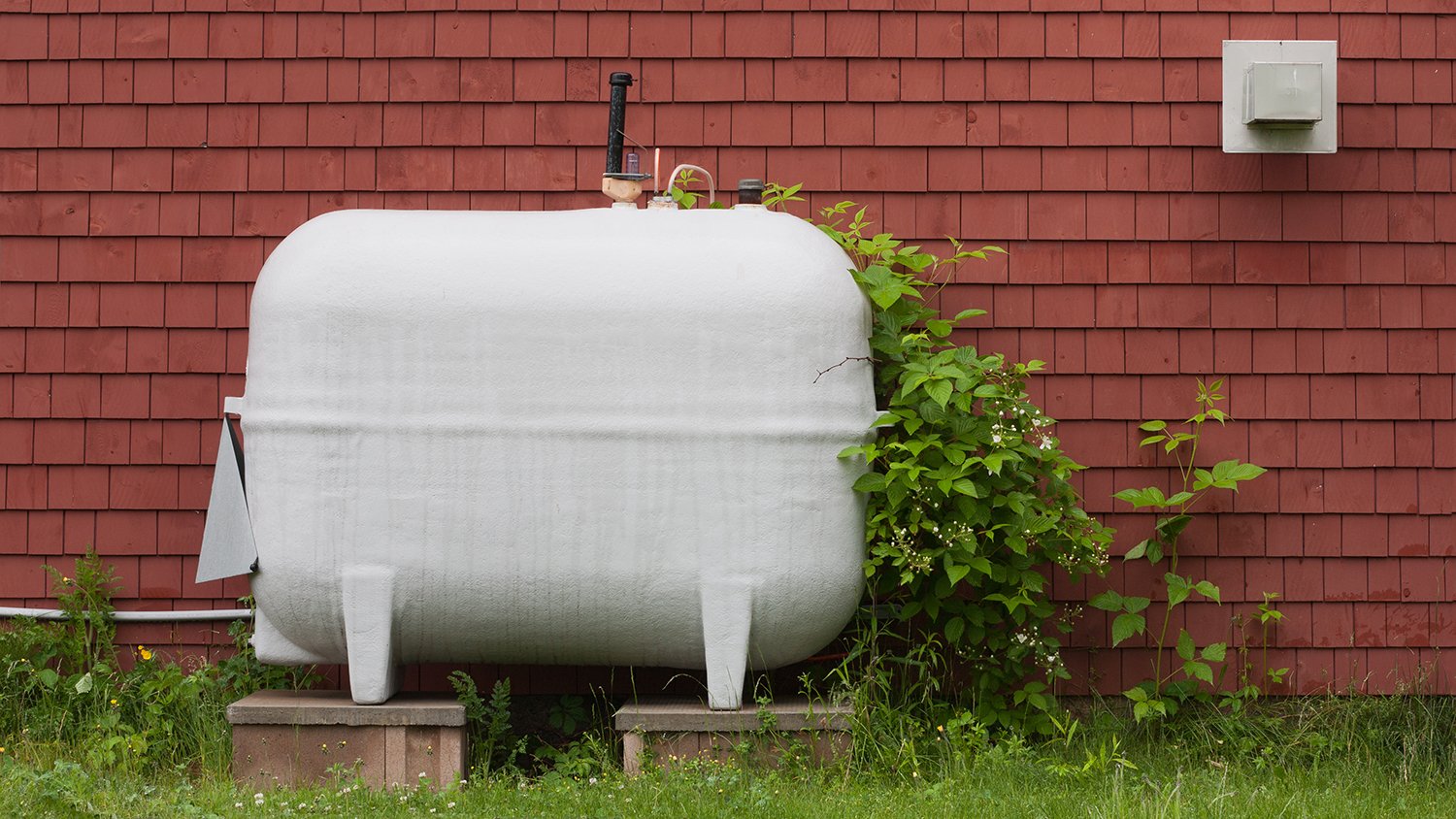 Heating fuel oil tank beside exterior wall