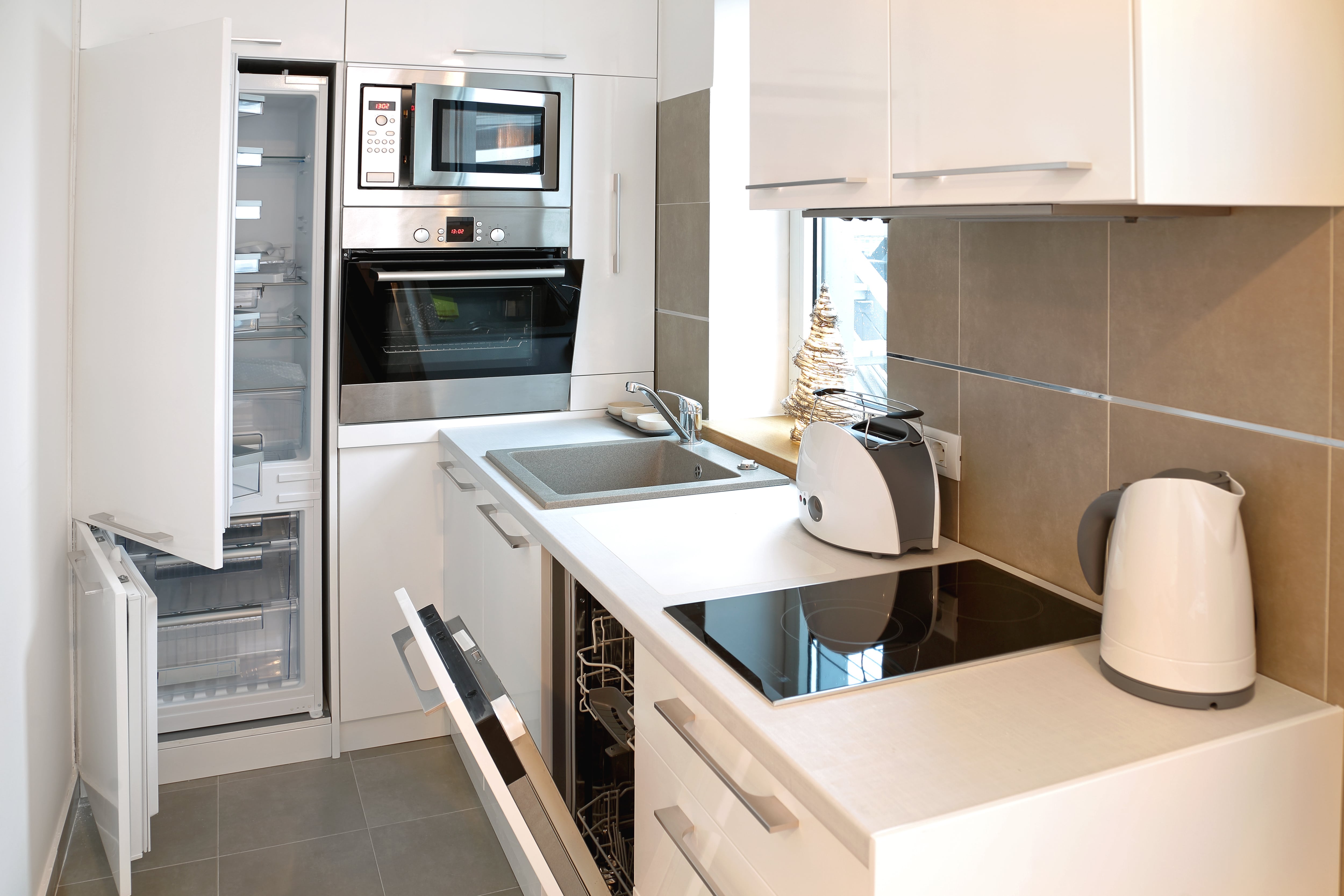 A small galley kitchenette in a studio apartment