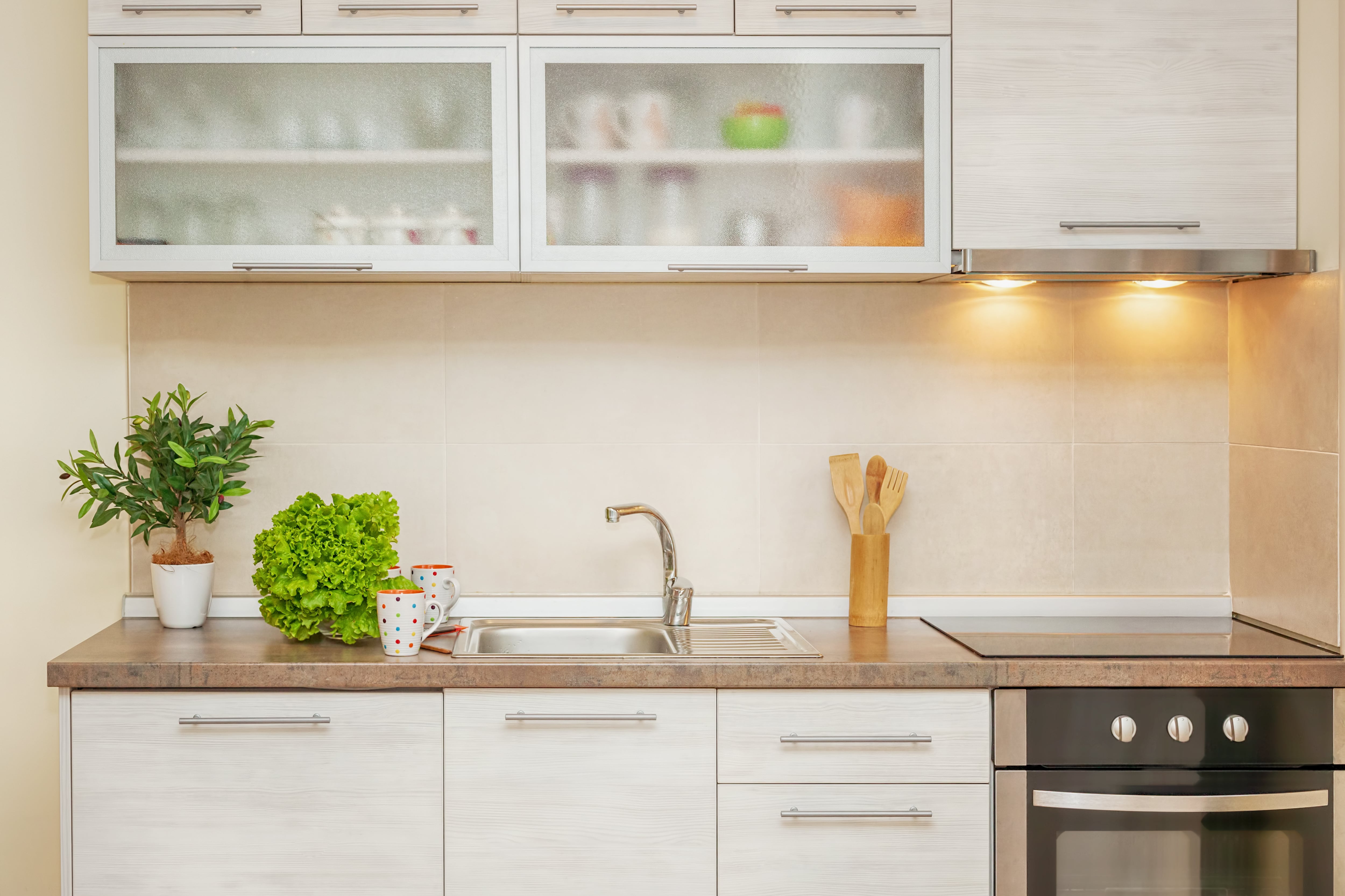 A small galley kitchen with white cabinets