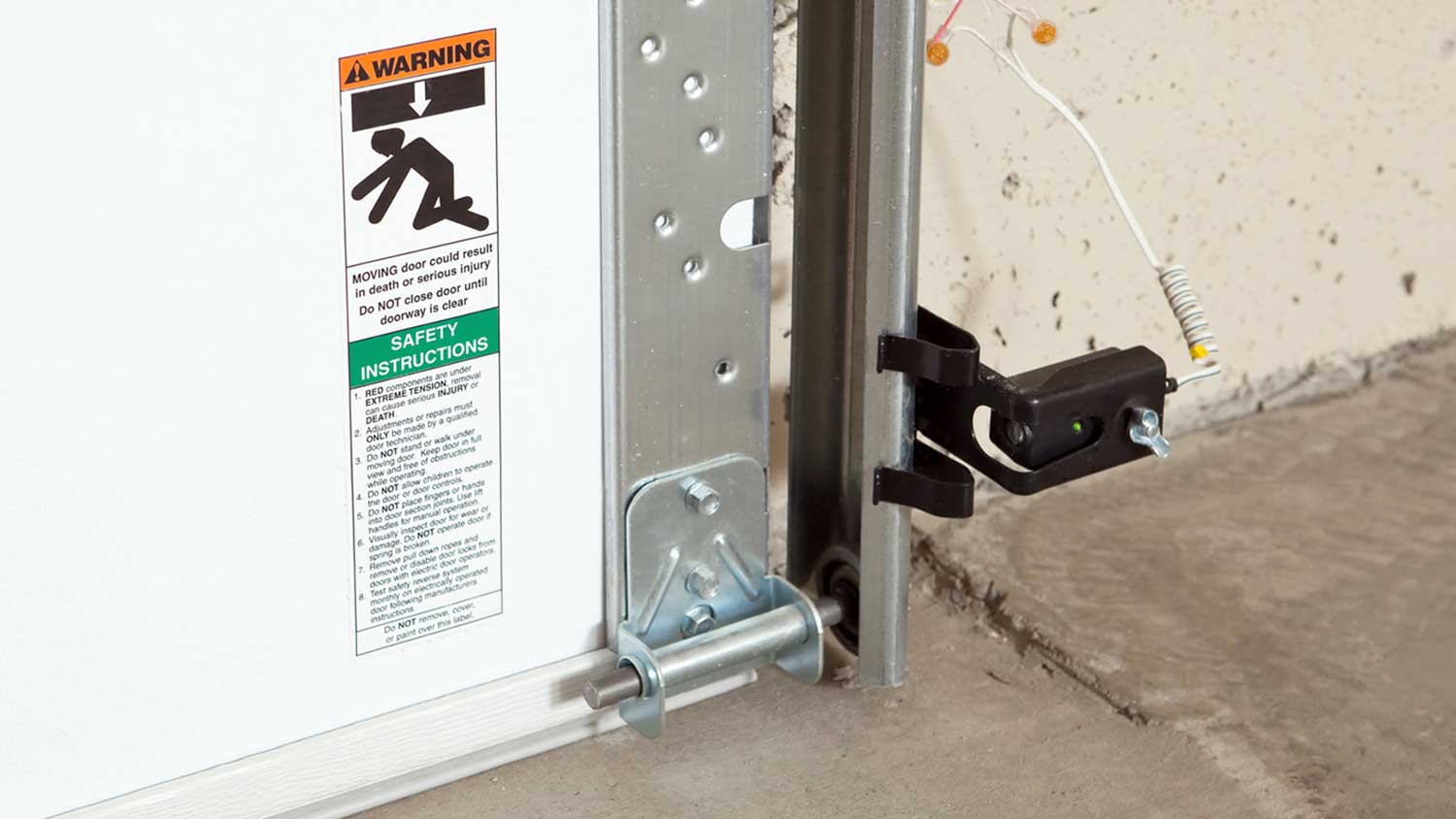 Garage door safety sensor installed at the bottom of the door