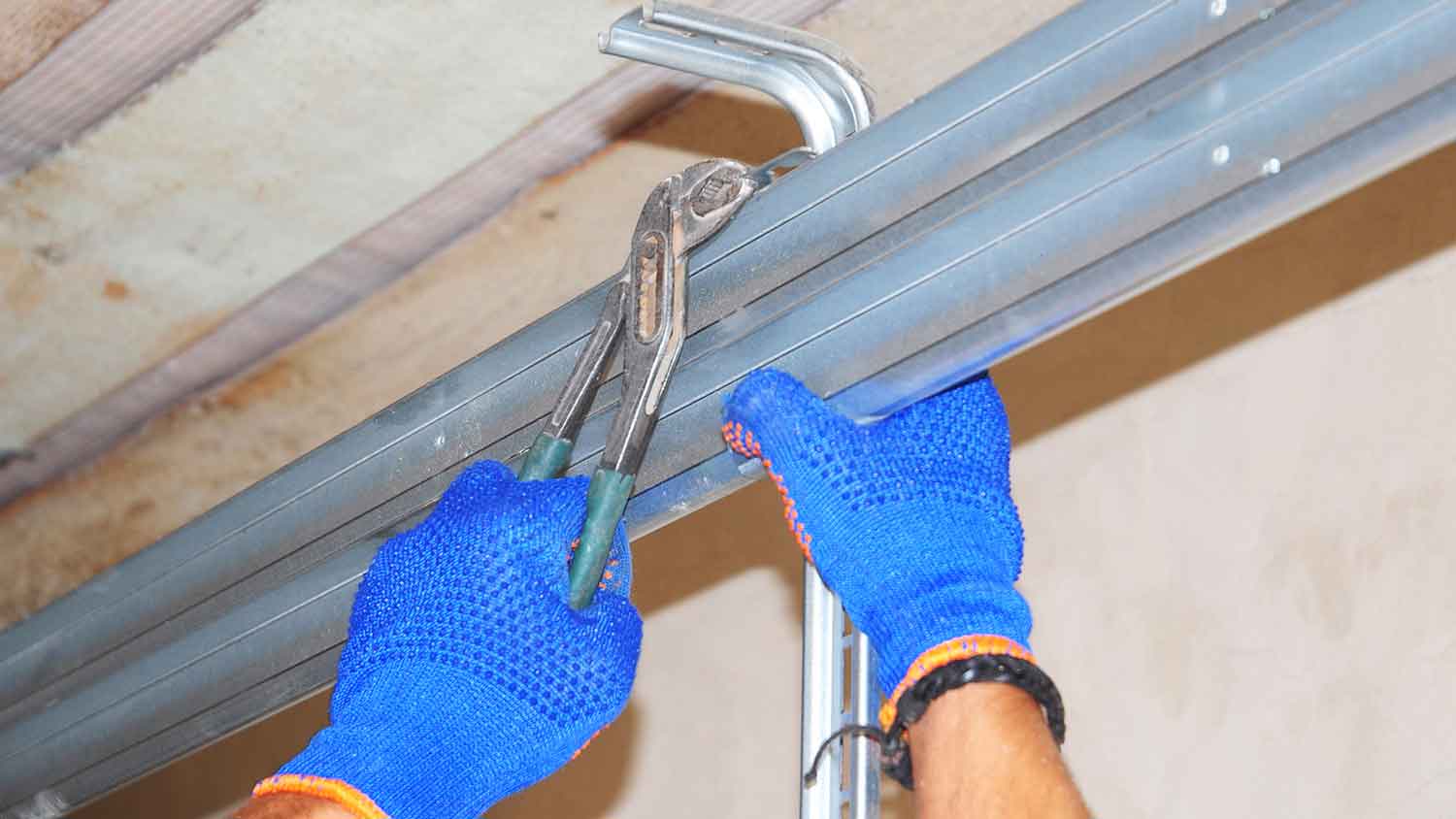 Technician installing garage door tracks 