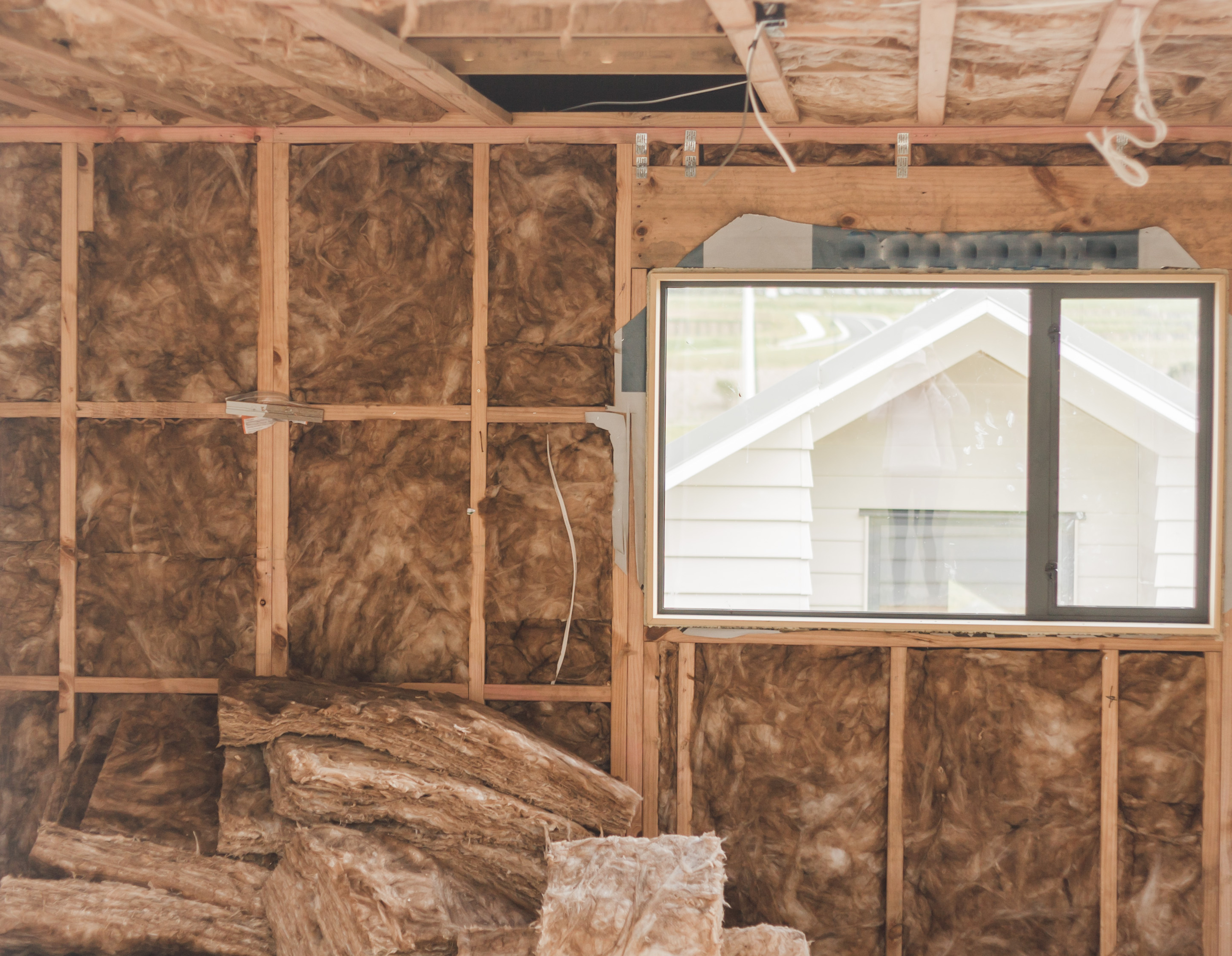 A large garage with insulation that’s under construction