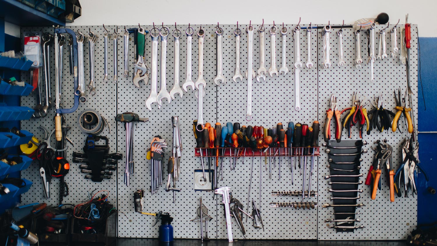 Garage tools lined up on a peg board