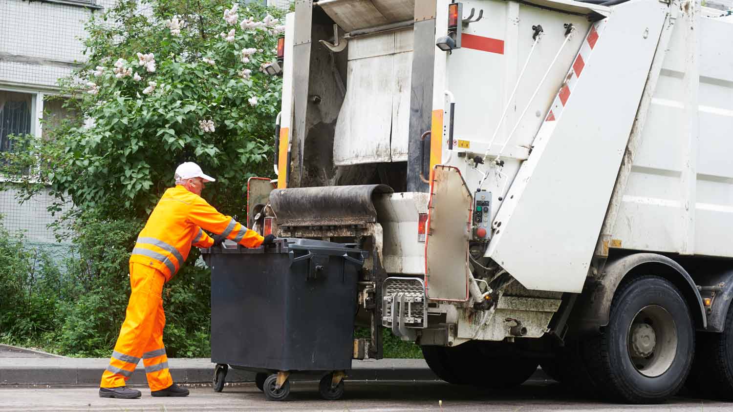 Garbage remover loading garbage truck