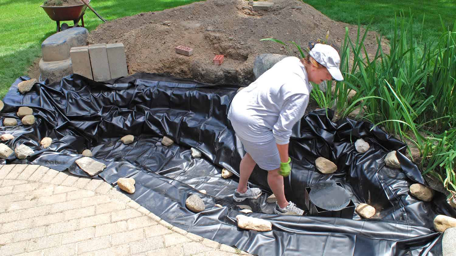 Contractor building a pond in the yard