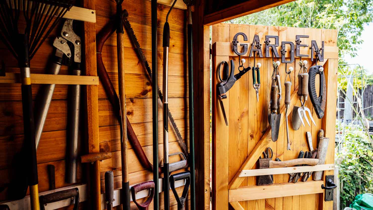 Garden tools organized in a wooden shed