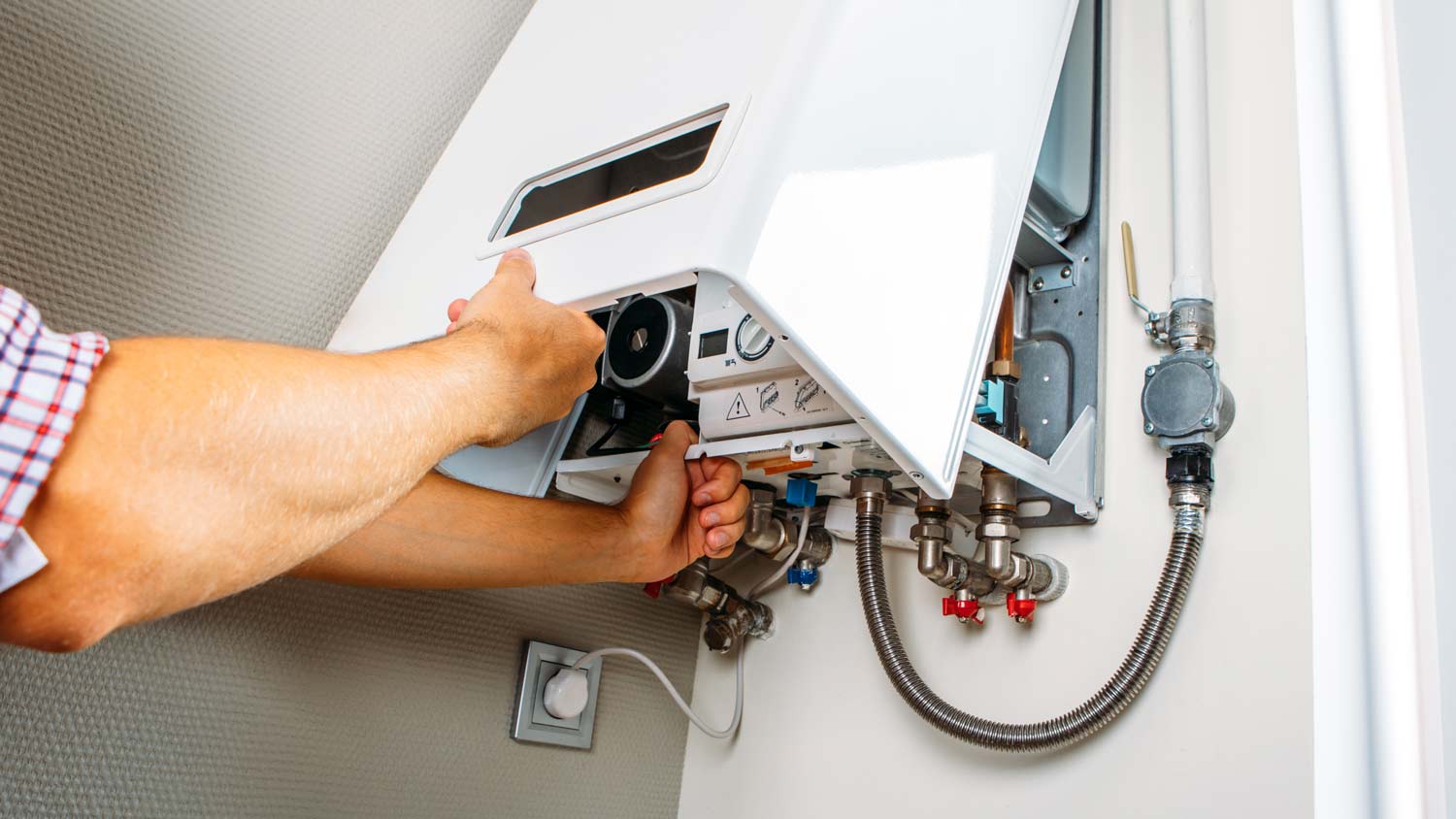 man doing an inspection on gas boiler