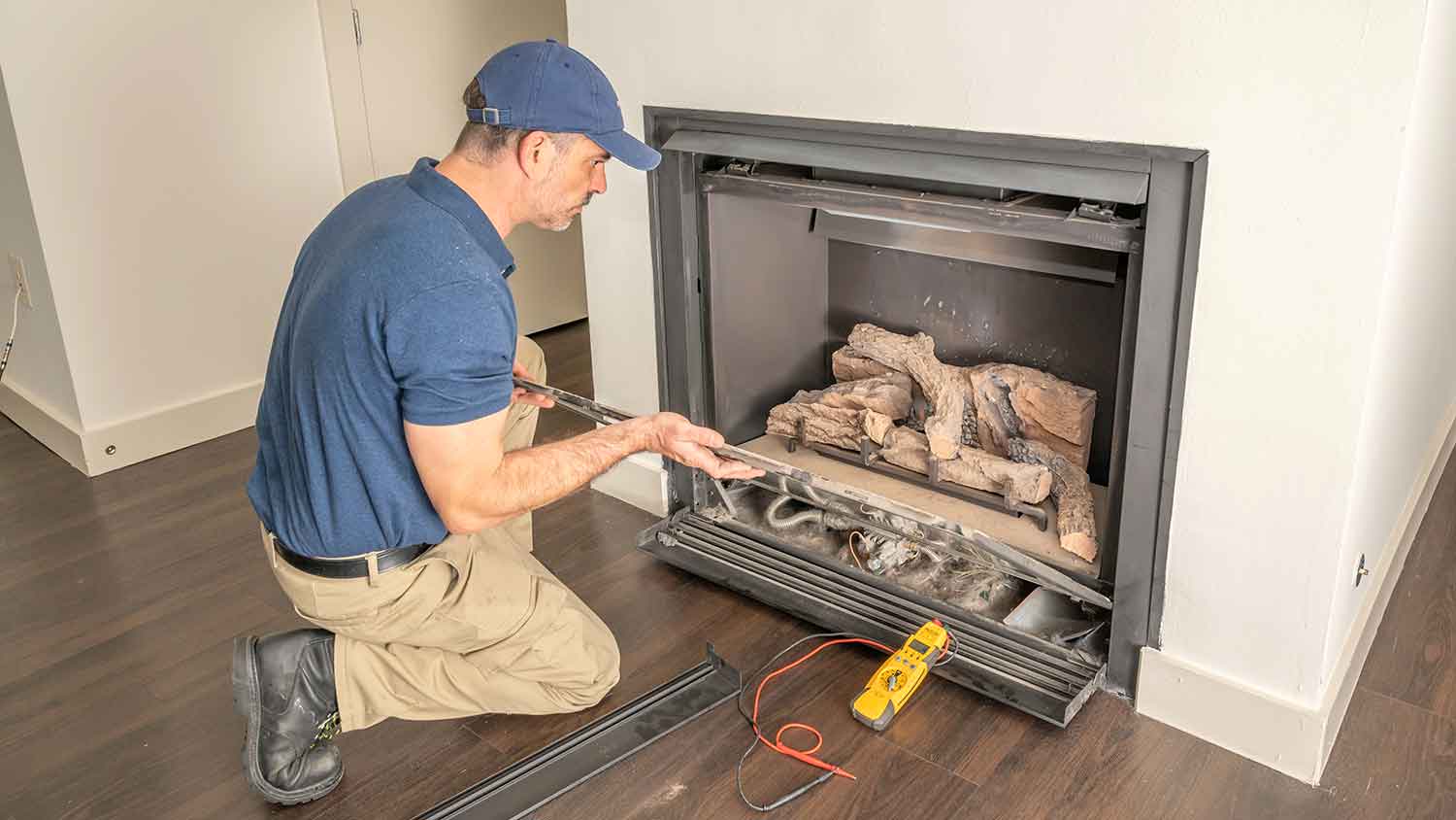 Technician repairing a gas fireplace