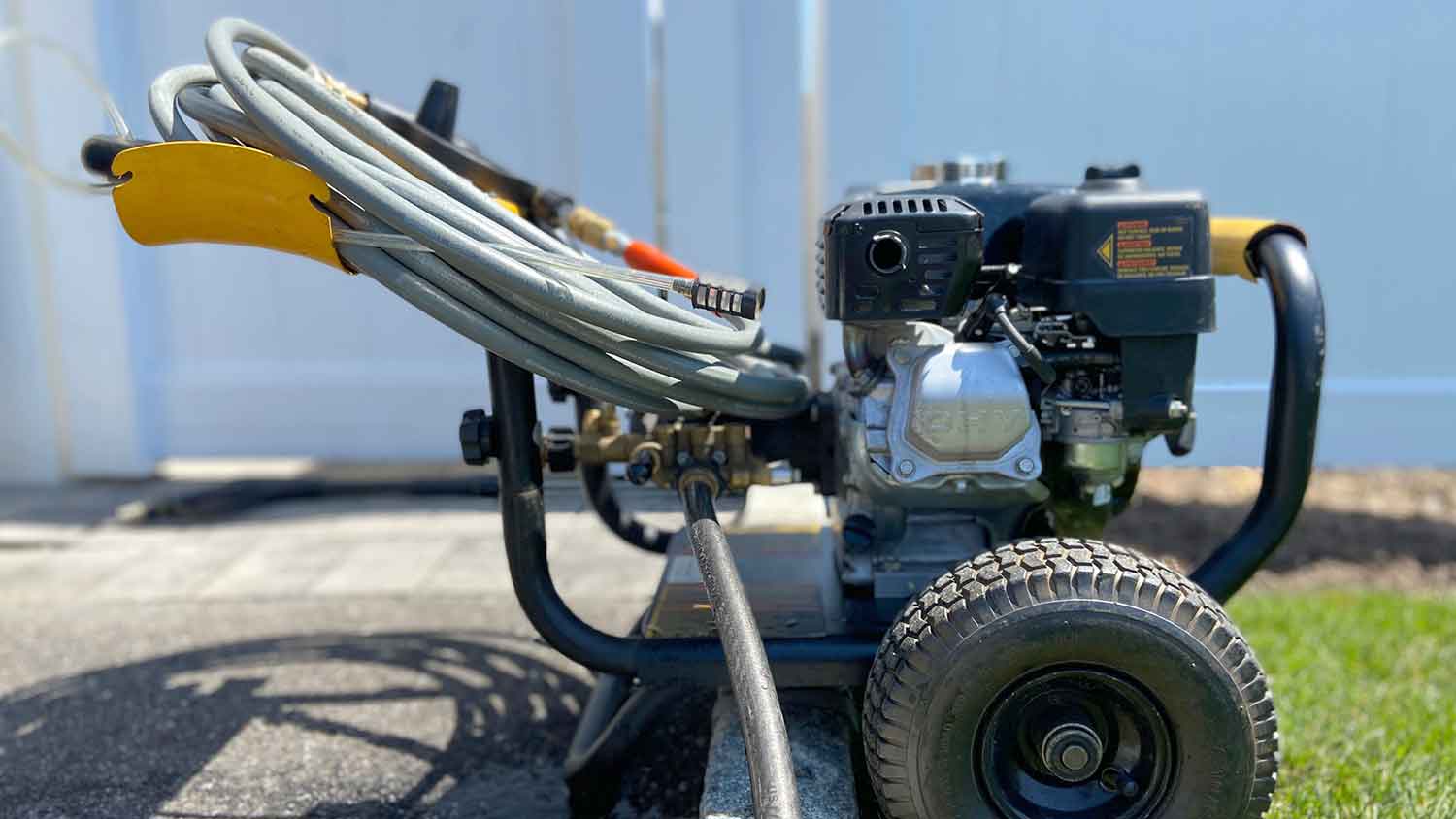 Closeup of a gas power washer sitting in the yard