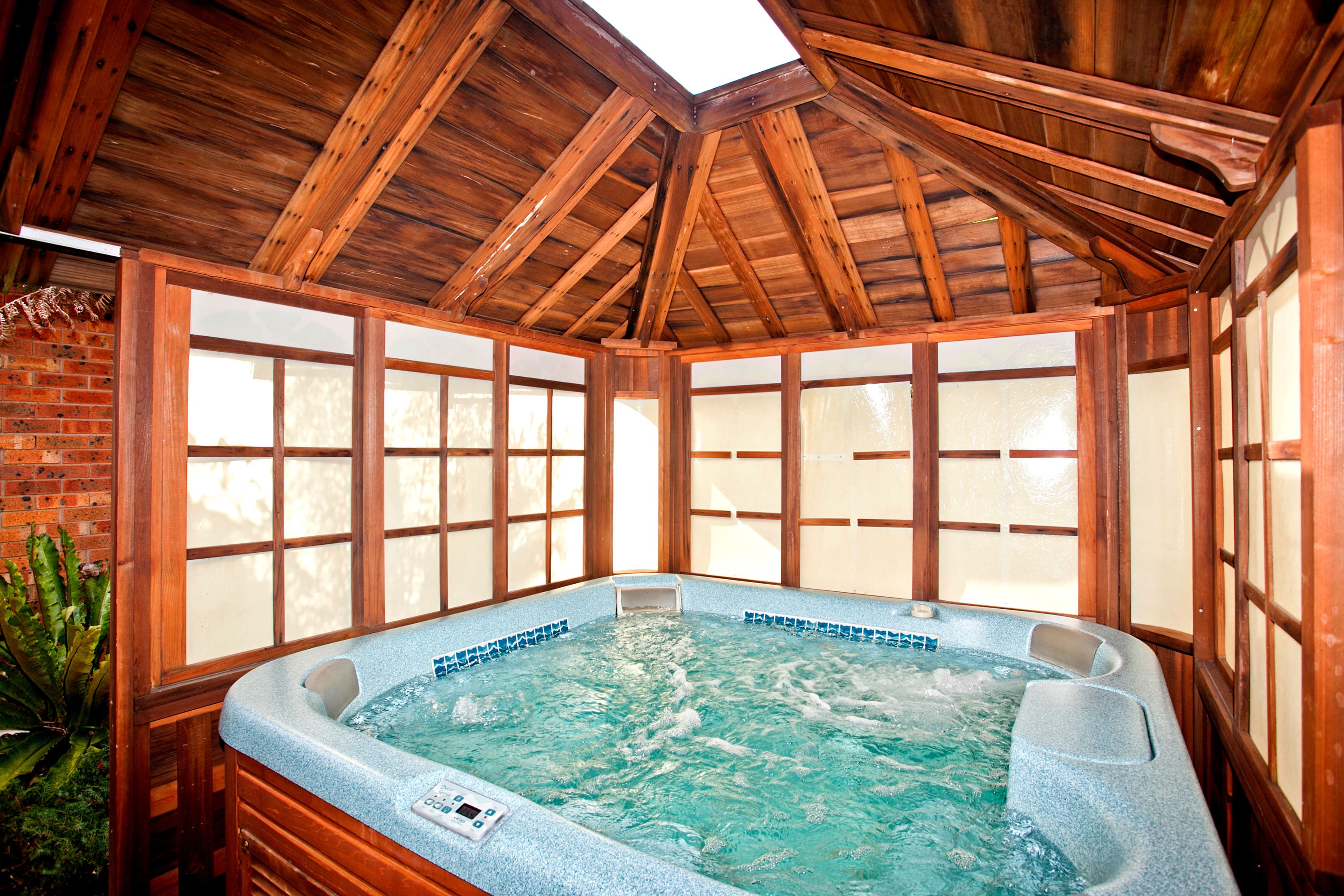 Hot tub under wooden gazebo