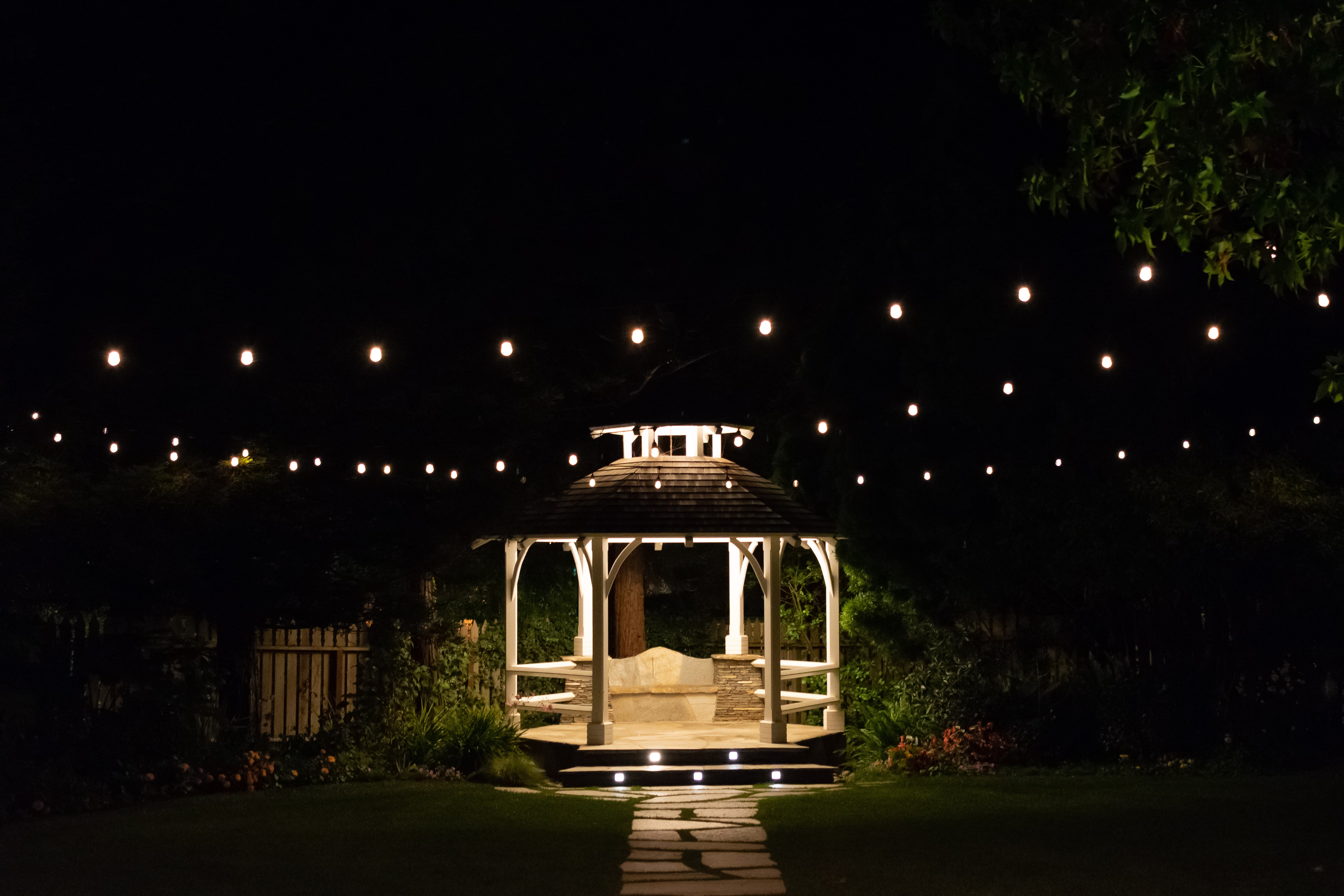 Outdoor gazebo at night with string lights