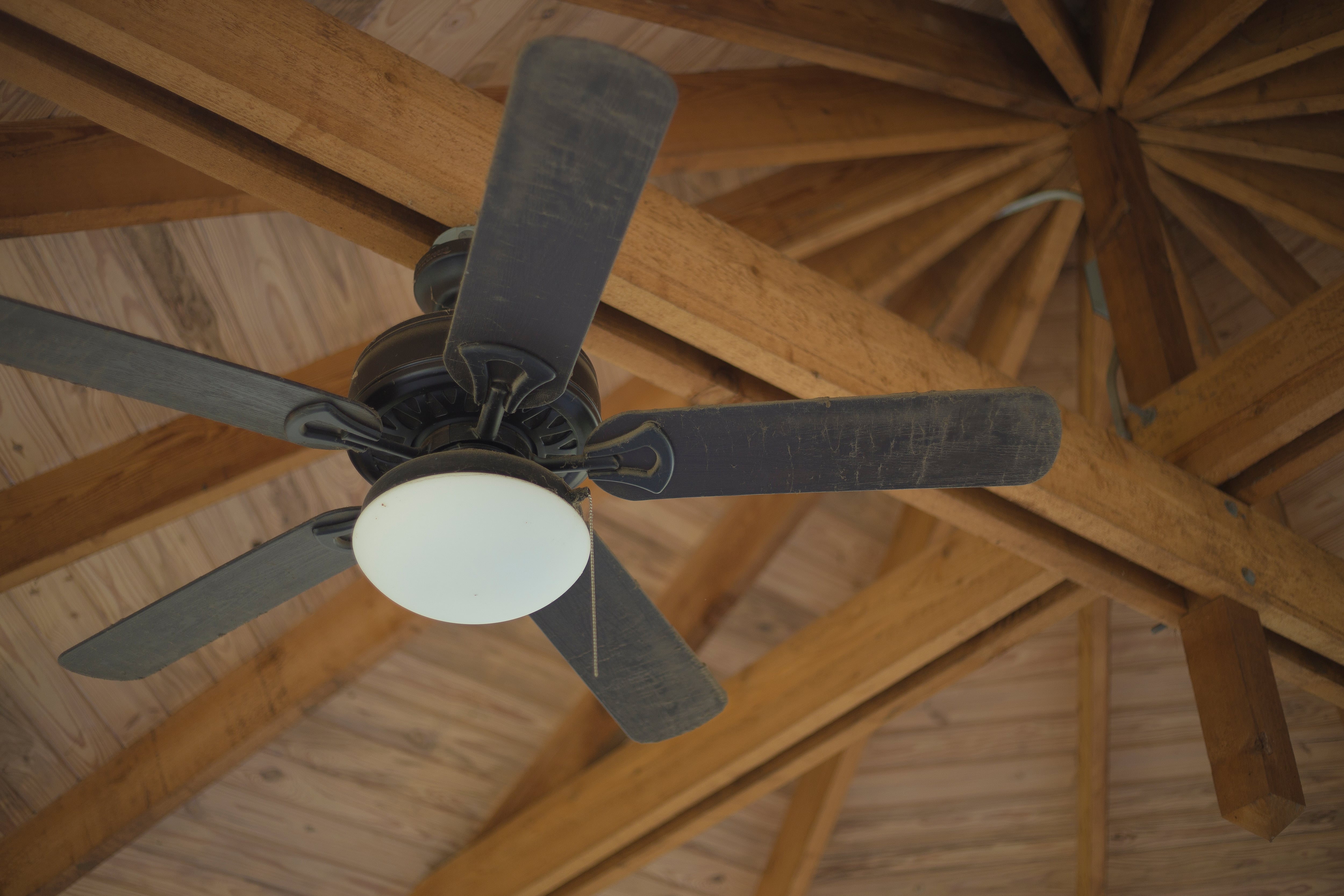 Ceiling fan hanging in wooden gazebo