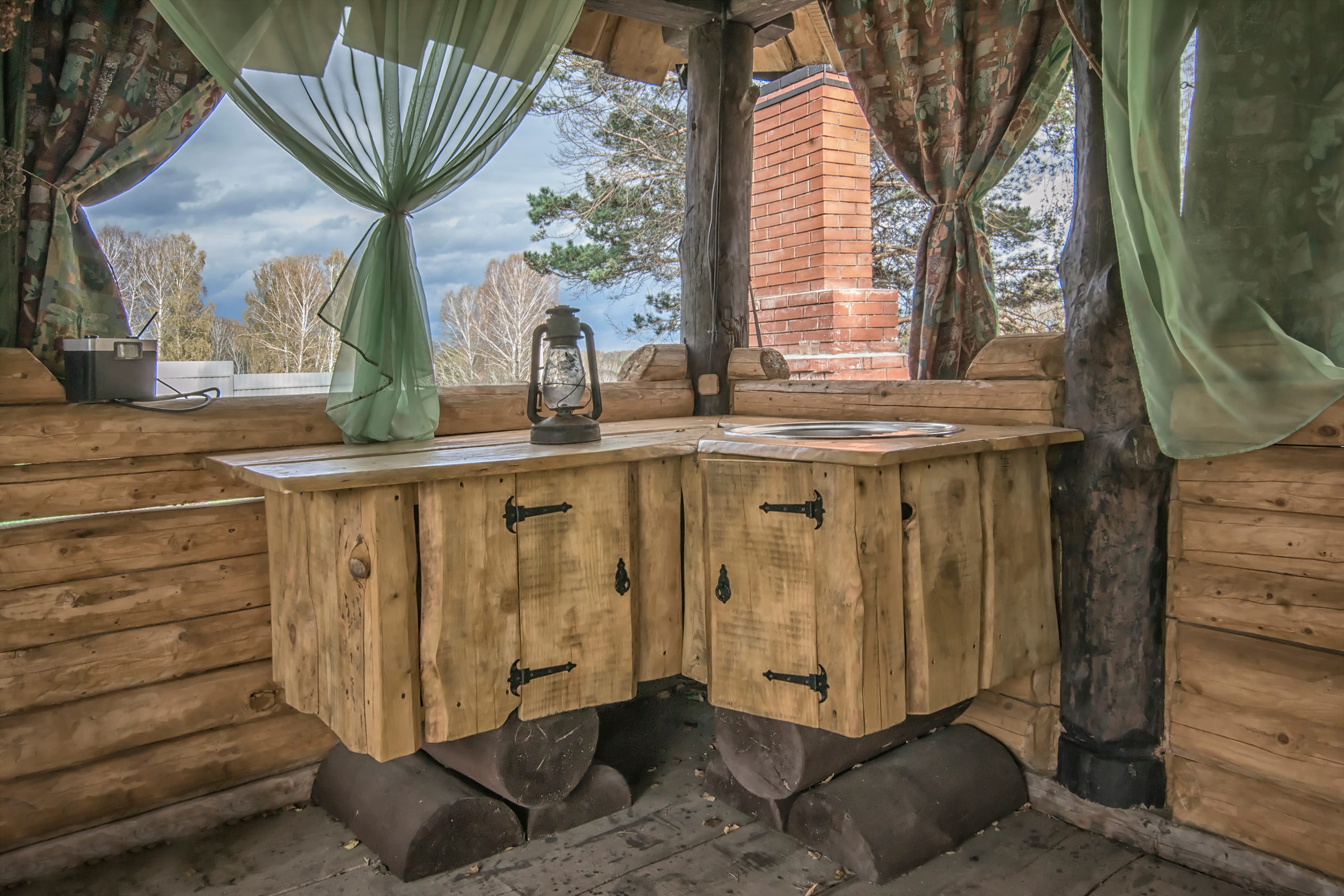 Outdoor kitchen in wooden gazebo