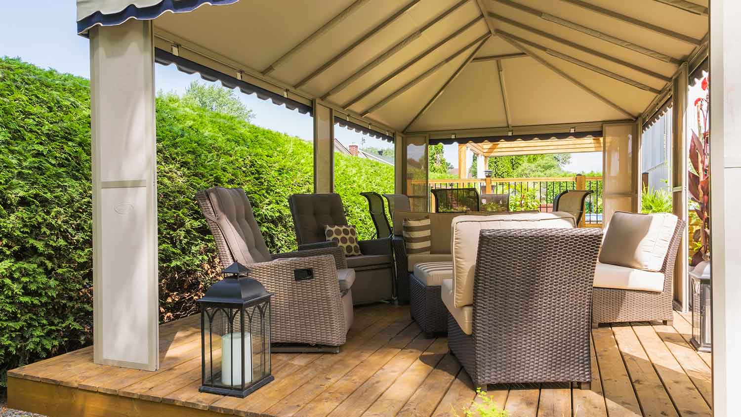 Gazebo on wooden deck with outdoor furniture