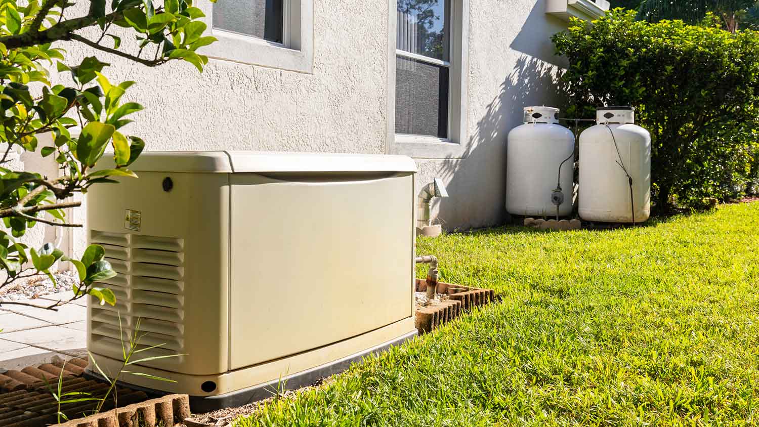 Generator and propane tanks installed outside of the house