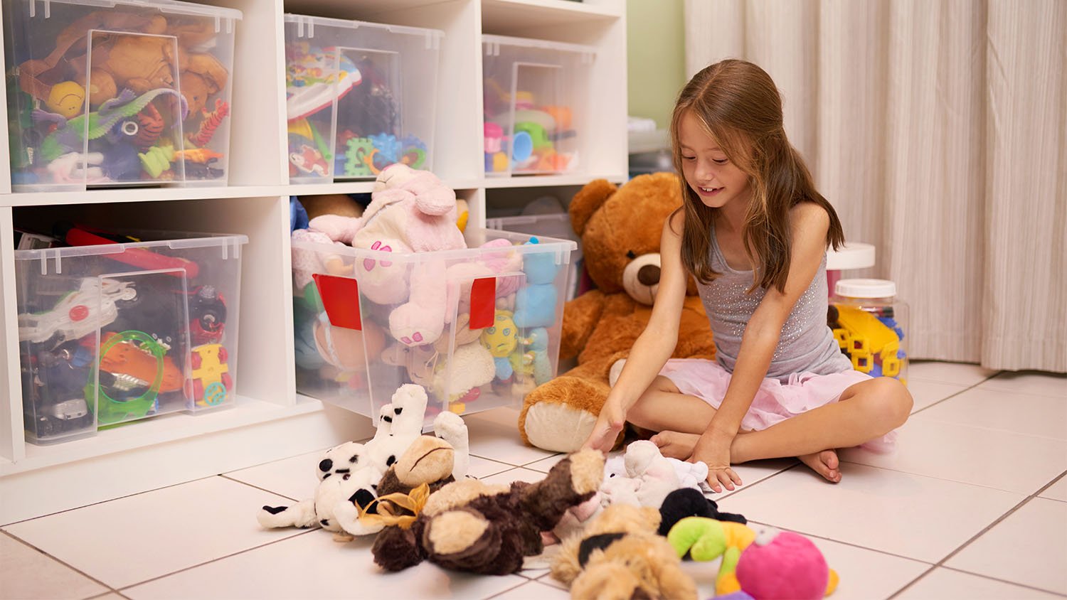 girl playing with stuffed animals