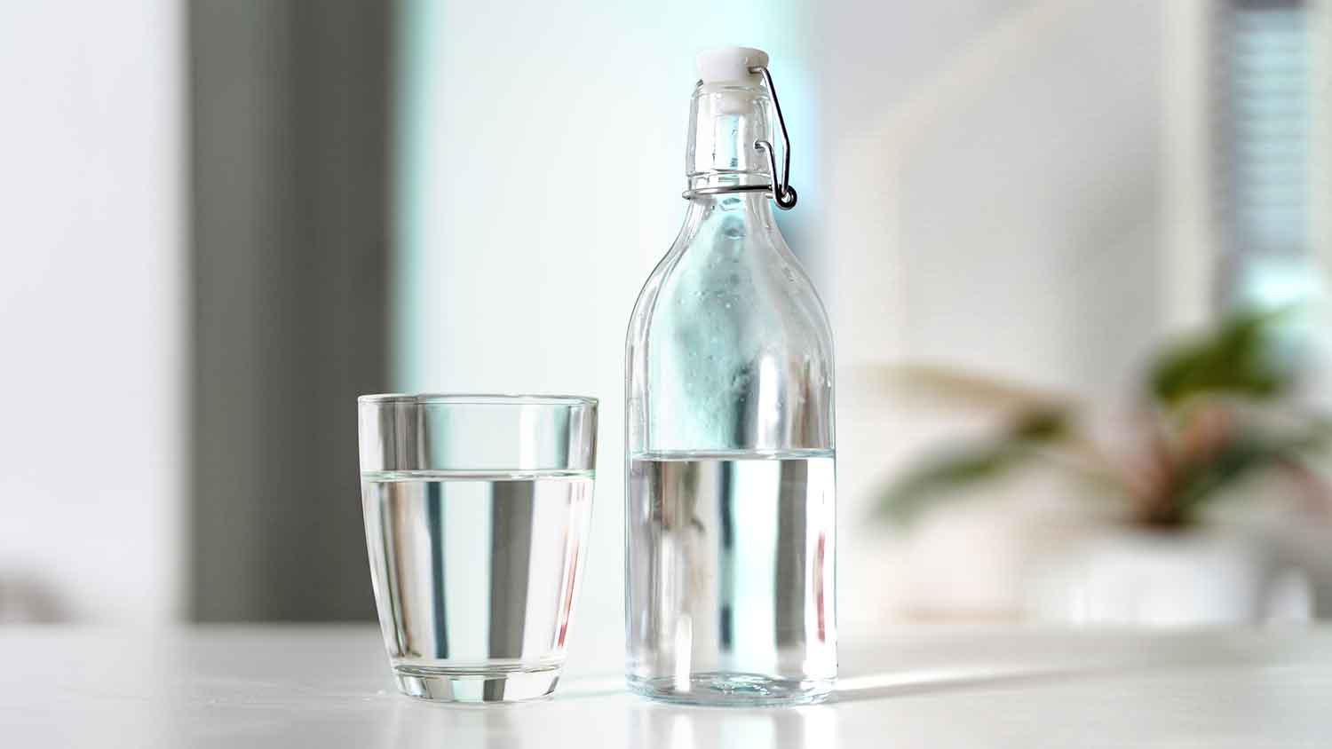 Galss with drinking water and a glass bottle