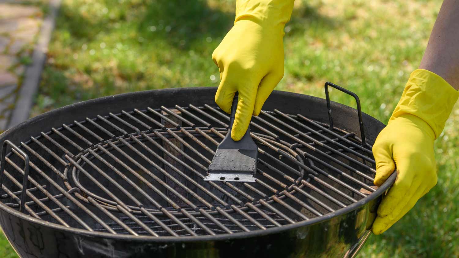 cleaning metal grate with wire brush