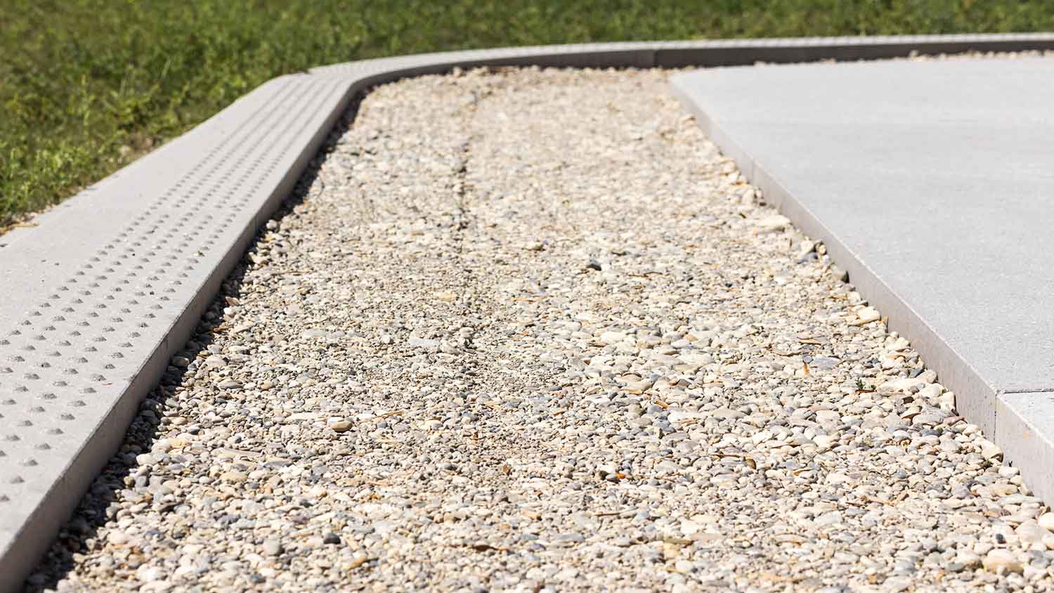 Concrete driveway with gravel French drain