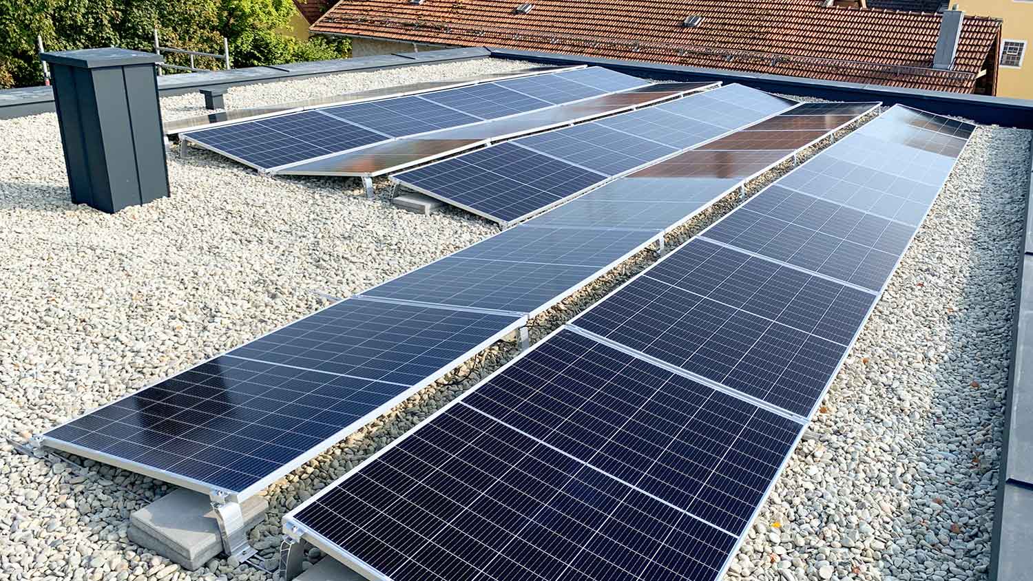 Solar panels installed on a flat roof covered with gravel