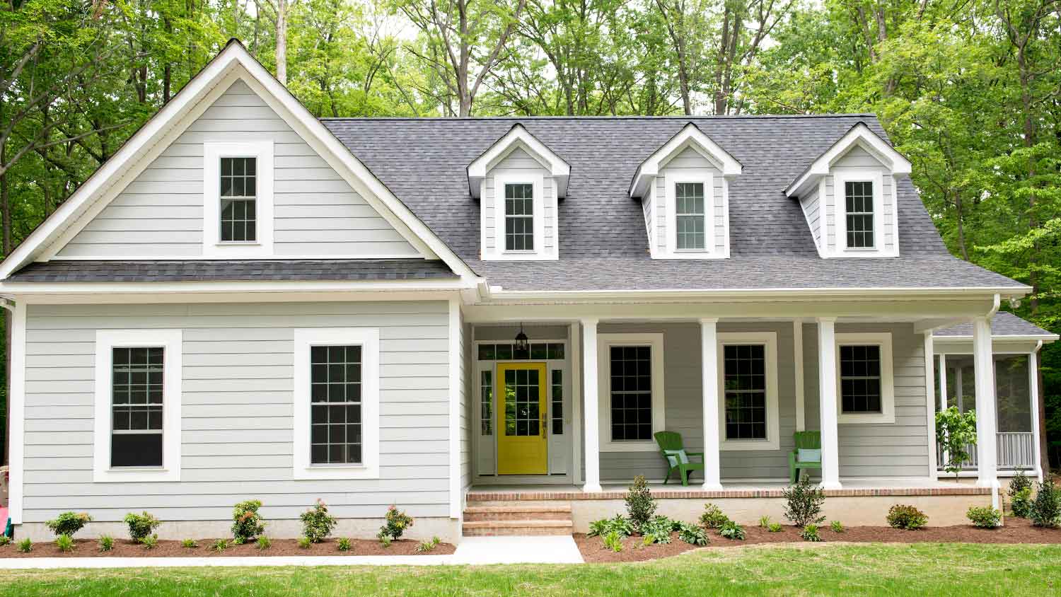 House with gray siding and yellow door