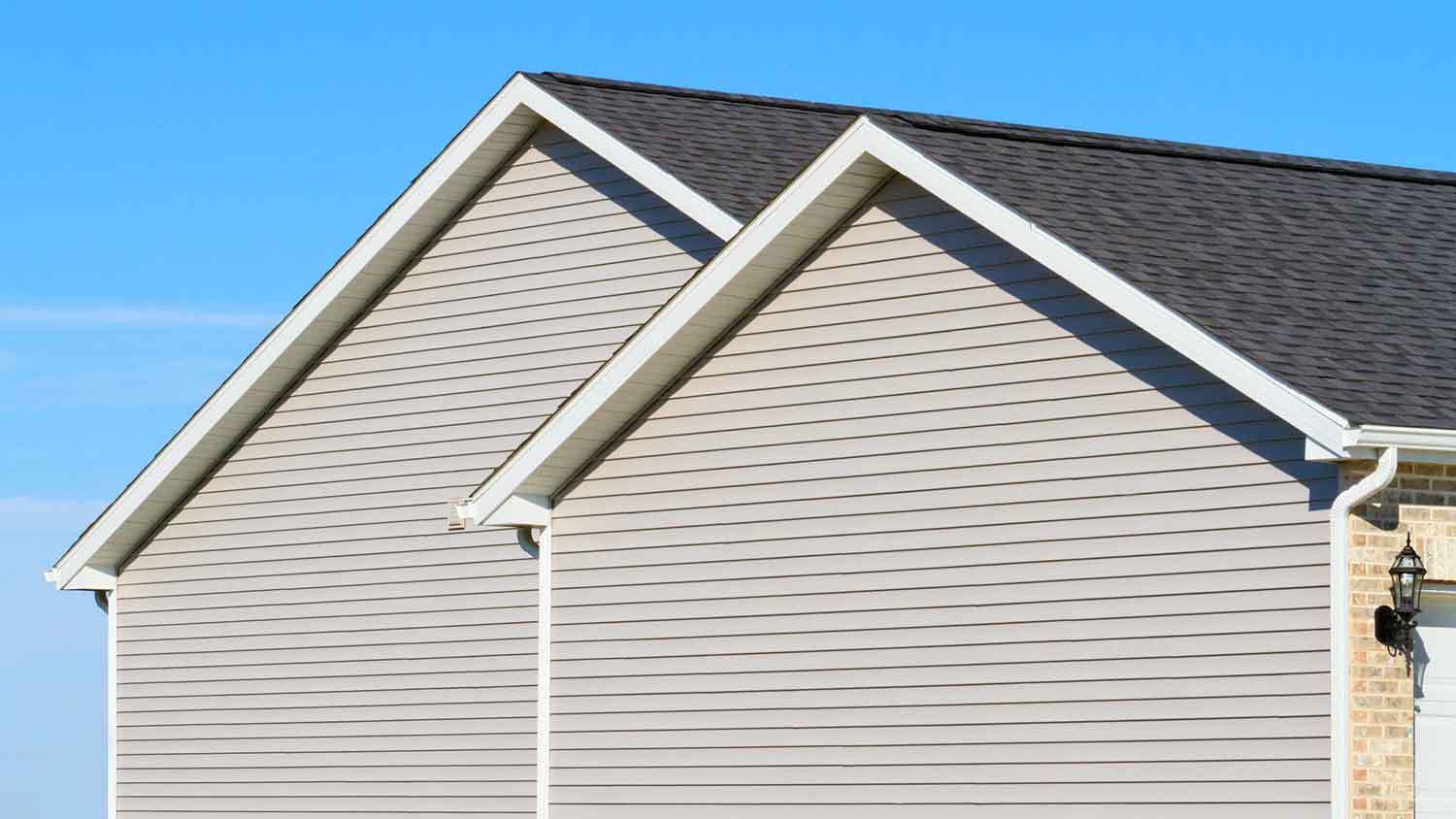 Gray vinyl cladding installed on the side of a house
