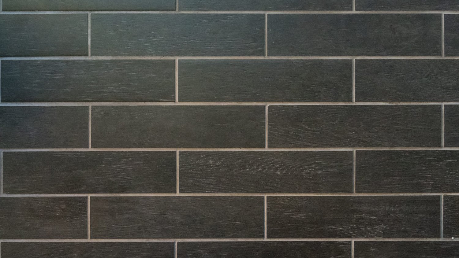 Long gray tiles with white grout